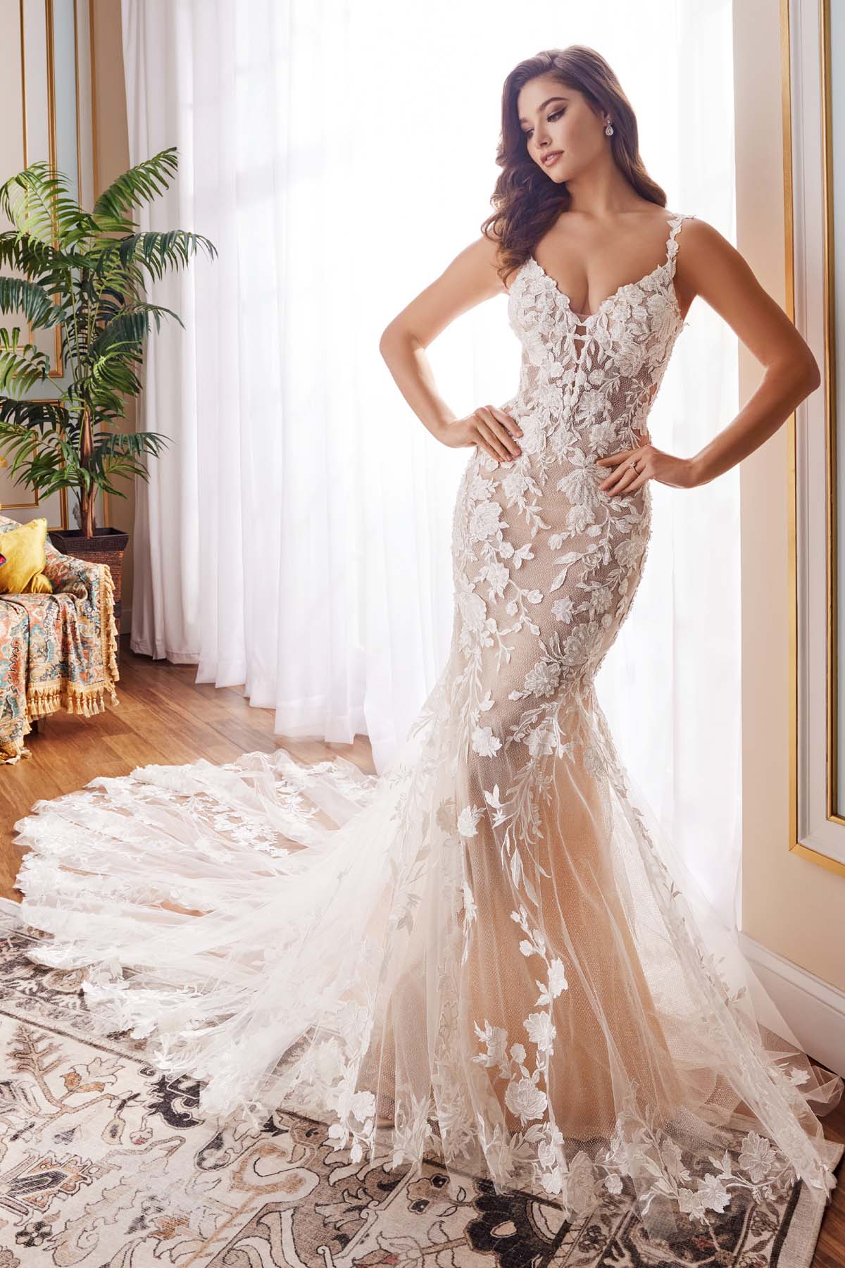 A bride wearing the Martin Thornburg MT5108 'Barrett' mermaid wedding dress in ivory with floral lace appliqués and a sweetheart neckline.